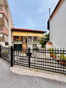 a black fence in front of a house at Alexis Suites Olympus in Litochoro