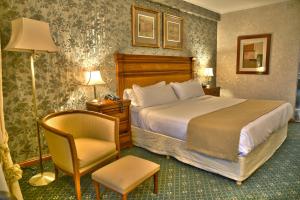 a hotel room with a bed and a chair at InterTower Hotel in Santa Fe
