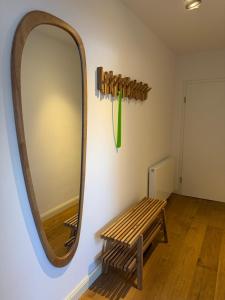 a mirror on a wall next to a wooden bench at MeerZeit in Orth
