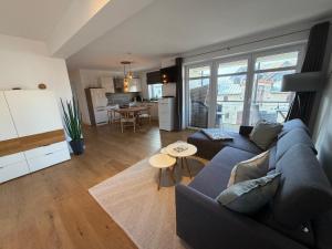 a living room with a couch and a table at MeerZeit in Orth
