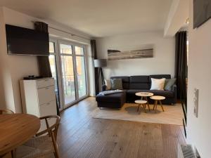 a living room with a couch and a table at MeerZeit in Orth
