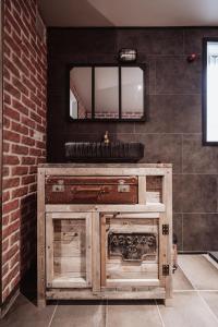 a bathroom with a wooden sink and a mirror at La Baguette du Sorcier - Logement insolite immersif jusque 4 personnes entre Liège & Maastricht in Visé