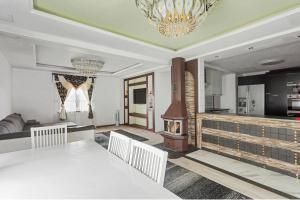 a dining room with a white table and a chandelier at حورية البحر in Bromölla