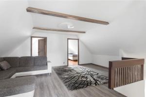 a living room with a couch and a rug at حورية البحر in Bromölla