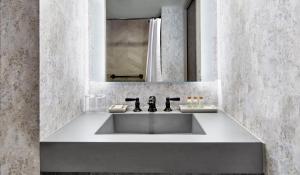 a bathroom with a sink and a mirror at Renaissance Mobile Riverview Plaza Hotel in Mobile