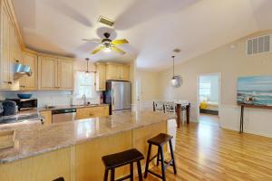 a kitchen with a large island in the middle at Worries not Found in Kill Devil Hills
