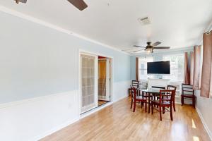 a dining room with a table and chairs at Worries not Found in Kill Devil Hills