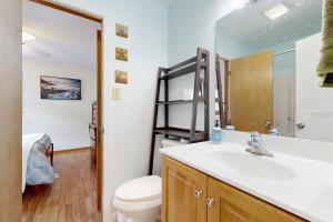 a bathroom with a sink and a toilet at Worries not Found in Kill Devil Hills +19 photos