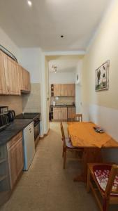 a kitchen with a wooden table and a dining room at Haus Elena am Semmering in Steinhaus am Semmering