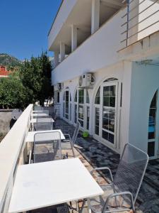 a row of tables and chairs outside of a building at Adriatic Villa Matea in Budva