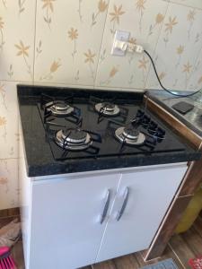 a stove top in a kitchen with a counter top at Suíte rural in Foz do Iguaçu