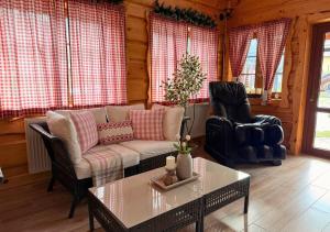 a living room with a couch and a table at Rusínsky Dvor s privátnym Wellness in Malý Lipník