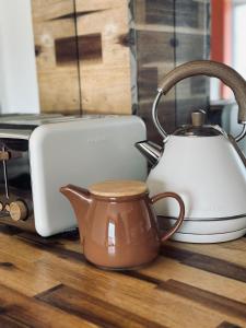 a tea kettle on a counter next to a toaster at Studio cosy - Porte de Genève & Voie Verte in Ambilly