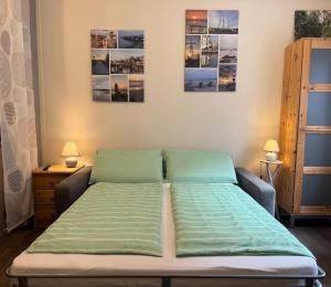 a bed in a room with two pictures on the wall at Gode Wind in Eckernförde