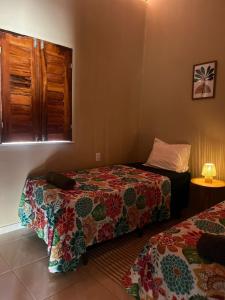 a hotel room with two beds and a window at Casa Tito in Cascavel +82 photos