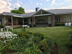 a house with a lawn in front of it at Anathi Hotel in Kokstad