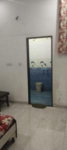 a mirror in a room with birds in the window at Chohan guest house in Khātu