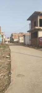 an empty street in a town with buildings at Chohan guest house in Khātu