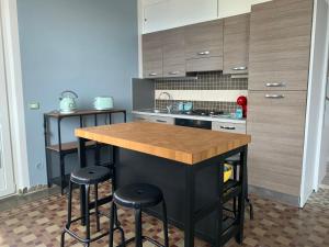 a kitchen with a island with two bar stools at La dolce vita in Intra
