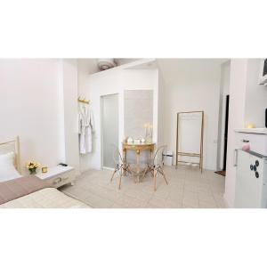 a bedroom with a bed and a table with chairs at Kharkiv Prime Center Apartmens on Sumska 46 in Kharkiv +73 photos