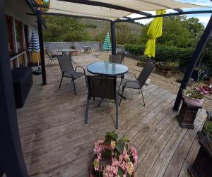 a patio with a table and chairs and an umbrella at Weingut Harald Konrad Fehres in Brauneberg