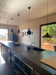 a kitchen with a counter with a sink and a counter sidx sidx at Villa K by Studio KO - Private Luxury Estate Marrakech in Marrakesh