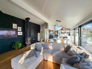 a living room with a white couch and a fireplace at Idyllic Modern House Overlooking Lammefjord in Vig