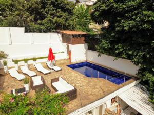 a patio with chairs and a swimming pool at casaJOMO in Rio de Janeiro