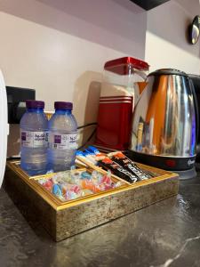 a tray with bottles of water and other items on a counter at شقة فاخرة بجاكوزي وبلياردو دخول ذاتي in Hail