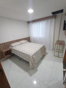 a bedroom with a bed in a room at Hotel Borza Carneiro in Piraí do Sul +6 photos