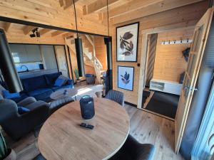 a living room with a table and a couch at Domek Dolina Żurawia in Borzynowo