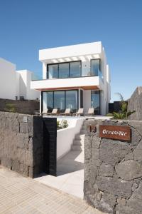 a white house with a sign in front of it at OCEANIQUE by Buenavilla in Tías