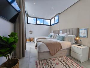 a bedroom with a large bed and a tv at OCEANIQUE by Buenavilla in Tías +8 photos