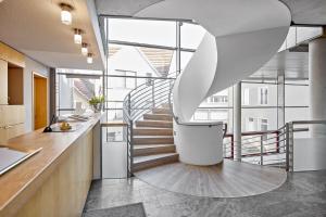 a spiral staircase in a kitchen with a stair case at Hotel an der Stadtmauer in Schorndorf
