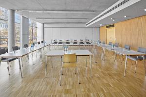 a large room with tables and chairs and a whiteboard at Hotel an der Stadtmauer in Schorndorf