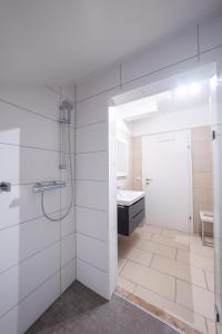 a bathroom with a shower and a sink at Fischerhaus in Moosburg +44 photos