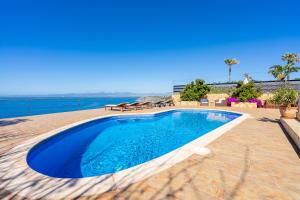 a swimming pool with a view of the ocean at Sa Torre Voramar in Sa Torre