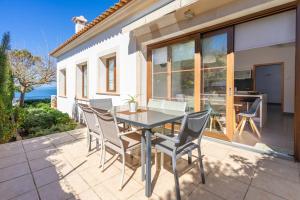 a patio with a table and chairs on a patio at Sa Torre Voramar in Sa Torre