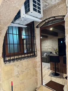 a stone wall with a balcony and a living room at rabat apartment in Rabat