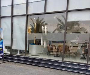 a store window with a table and chairs in it at BenHill - serviced apartment-Binh Duong in Ấp Dừa