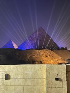 a view of the pyramids of egypt at night at Monument Pyramids View in Cairo