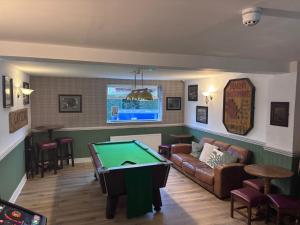 a living room with a pool table in it at Liberal House Tamworth in Tamworth
