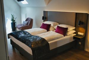 a bedroom with a large bed with a headboard at Residence Black Eagle Lubmin Strand in Lubmin
