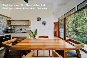 a dining room with a wooden table in a kitchen at Villas Roca del Caribe in Puerto Viejo