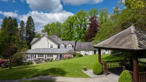 an estate with a large white house with a gazebo at Briery Wood Hotel in Ambleside