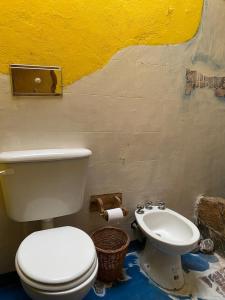 a bathroom with a toilet and a bidet at Luna Huasi Posada in Maimará