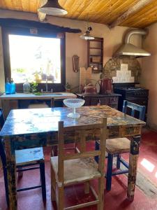 a kitchen with a large wooden table and chairs at Luna Huasi Posada in Maimará