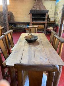 a wooden table with a bowl on top of it at Luna Huasi Posada in Maimará +6 photos