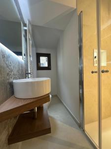 a bathroom with a sink and a shower at Piazza Sant'Agostino Rooms in Bagnoregio +10 photos