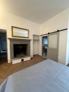 a bedroom with a bed and a fireplace at Piazza Sant'Agostino Rooms in Bagnoregio
